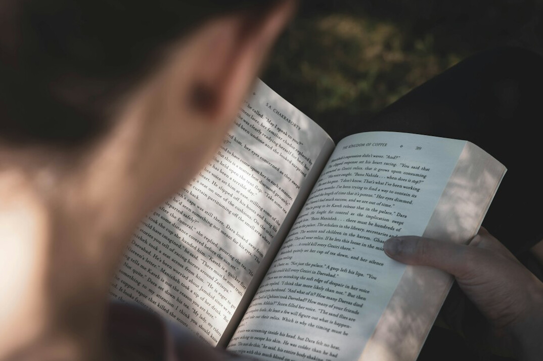 person turning book page